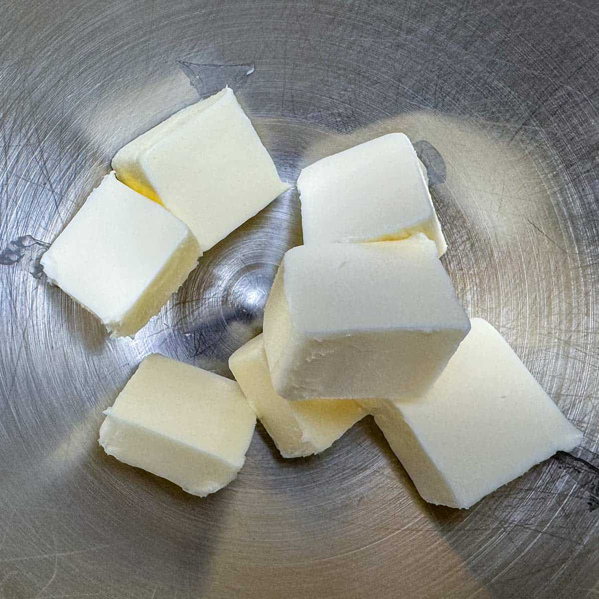 Cubed butter in a mixer bowl.