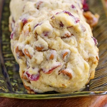 A front photo of a Cranberry Cinnamon Caramelized Wanut Cookie on a small plate.