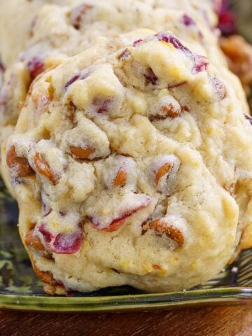 A front photo of a Cranberry Cinnamon Caramelized Wanut Cookie on a small plate.