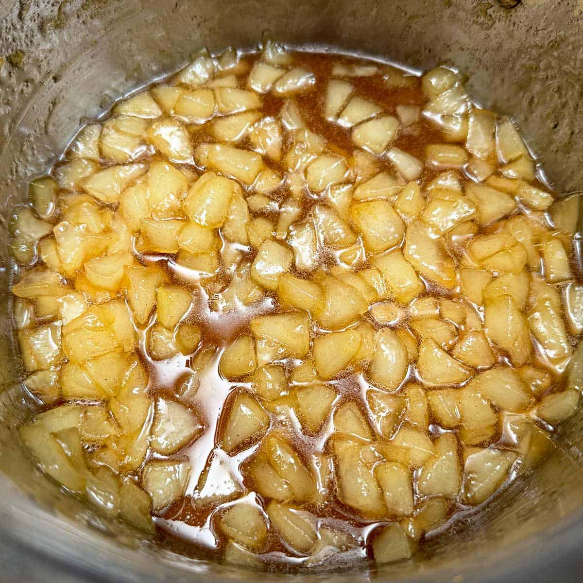 Reducing the pear liquid to become cut up pears in a syrup.