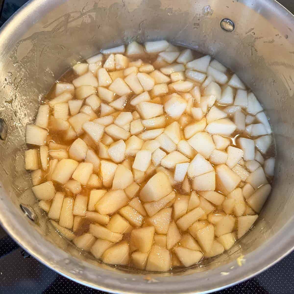 Heating the pears with all the ingredients in a sauce pan.