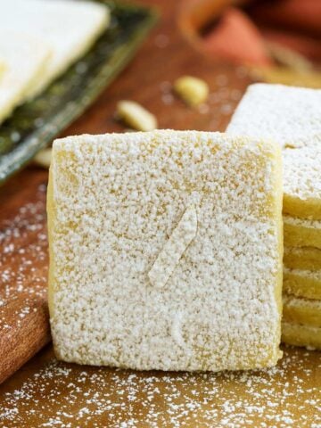 Italian almond with lemon cookies single cookie closeup on a wooden board.