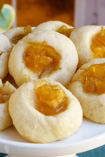 Finished thumbprint cookies with pear filling on a dish.