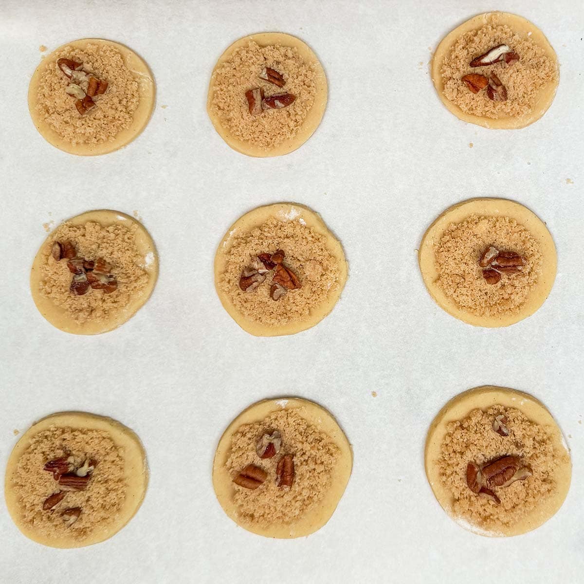 Cookies with the crumble and pecans on top ready for the oven.