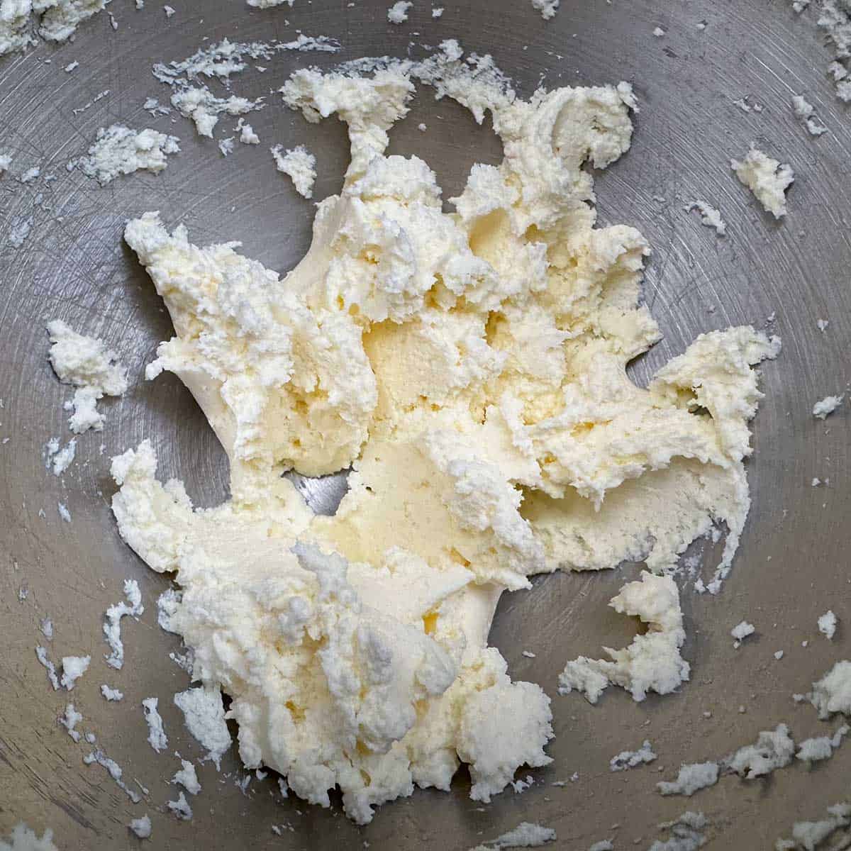 Butter and cream cheese mixed in a mixer bowl.