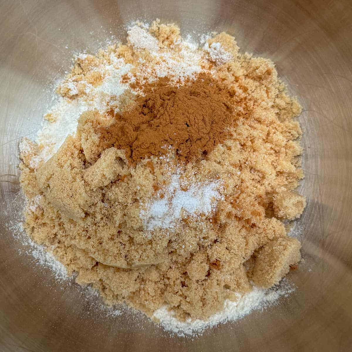 Adding all the dry ingredients for the crumble topping into a mixer bowl.