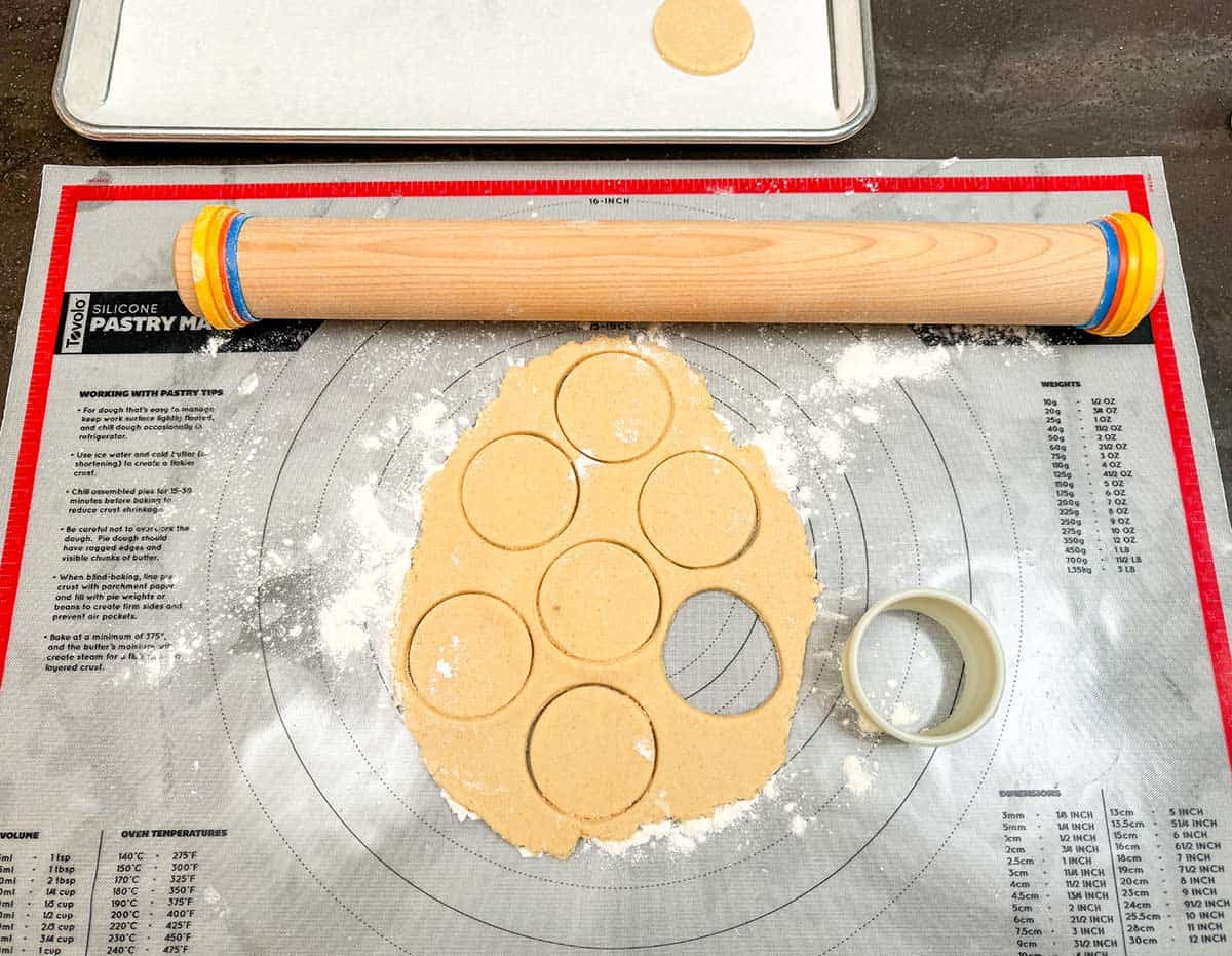 Cookie dough that has been rolled out and circles cut with a cookie cutter.