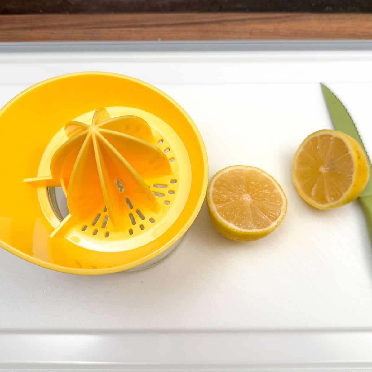 Lemon cut in half ready to be squeezed using the lemon juicer.