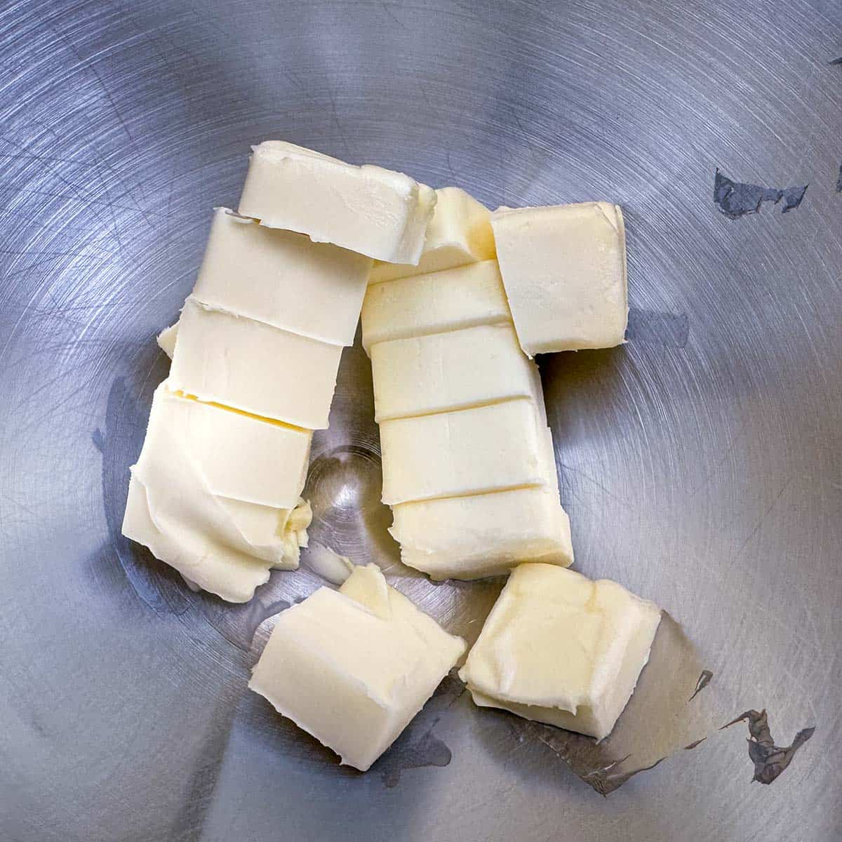 Cubed butter in a mixer bowl ready to be creamed.