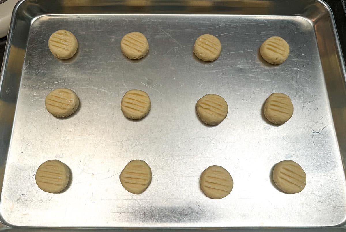 Rolled cookie dough into balls and marked with fork impressions.