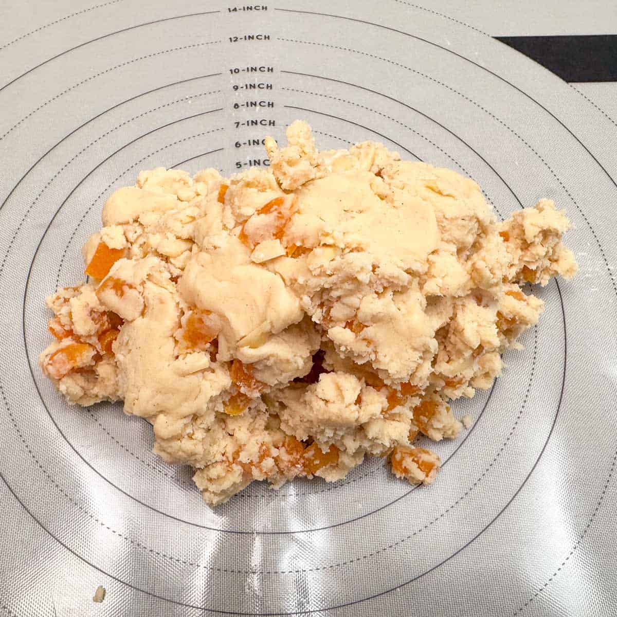 Placing the mixed cookie dough onto a pastry mat.