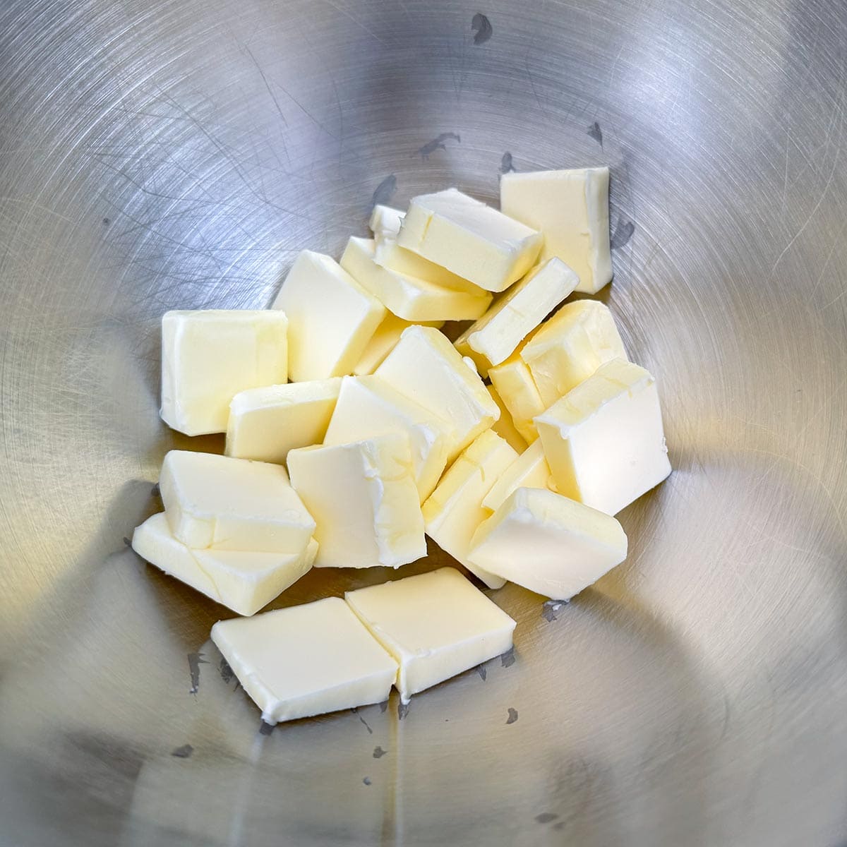 Softened cubed butter in a mixer bowl.