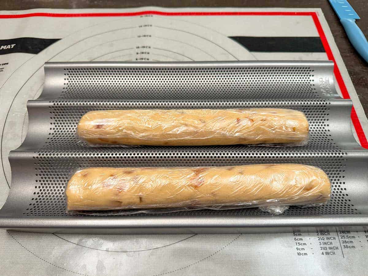 Using a baguette pan for holding rolls in the refrigerator.