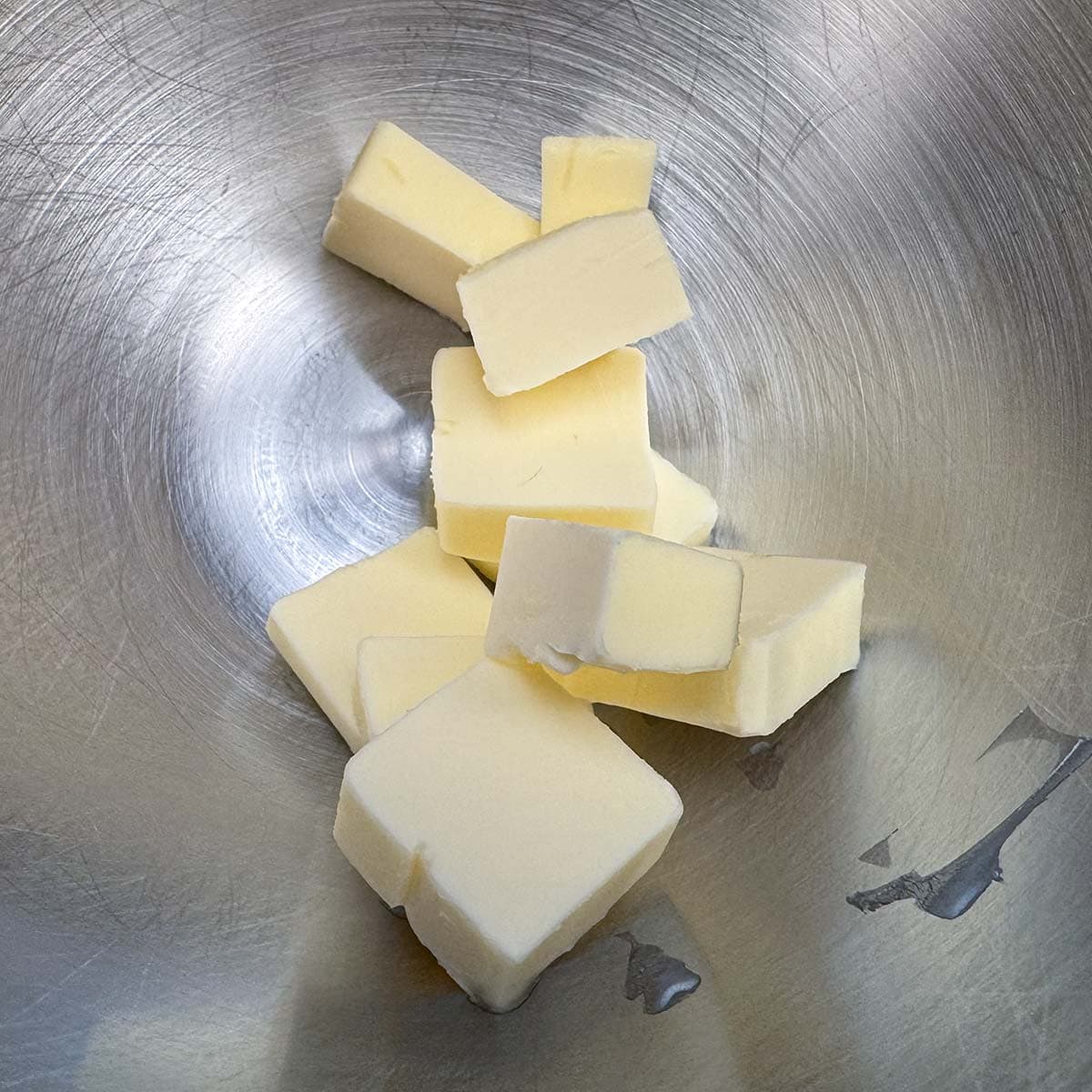 Cubed butter in a mixer bowl.