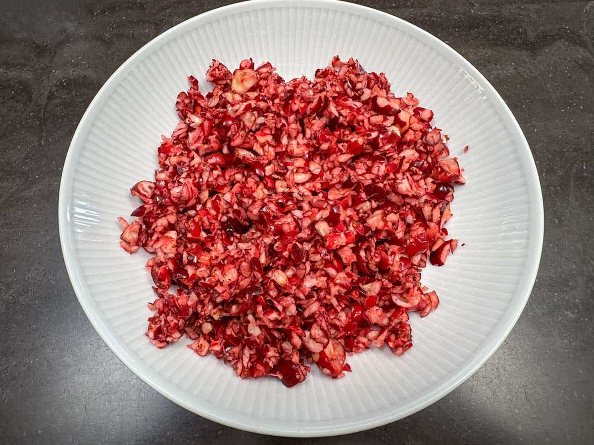 All the chopped cranberries have been added to a bowl to check for any big pieces.