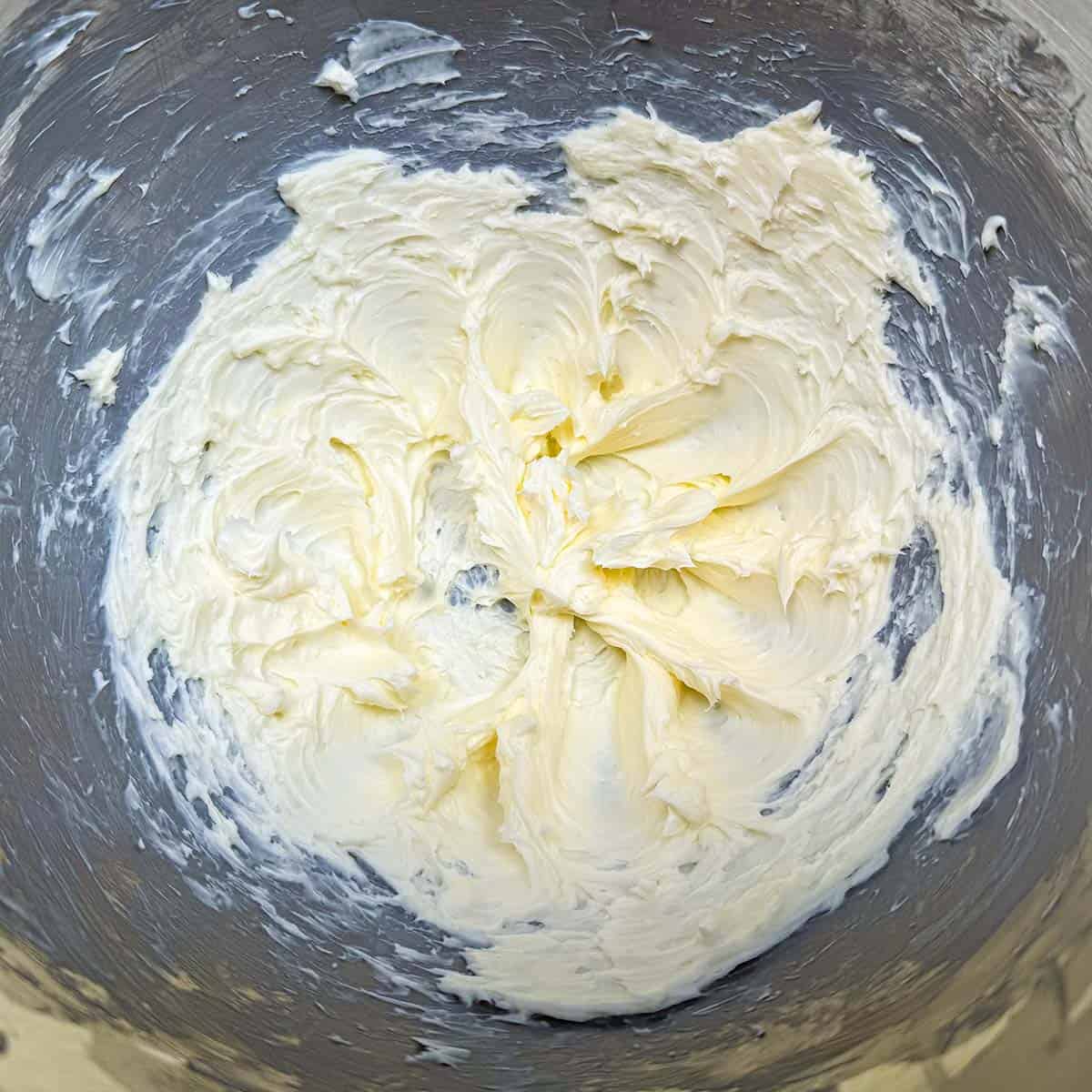 Creamed butter for the frosting in a mixer bowl.