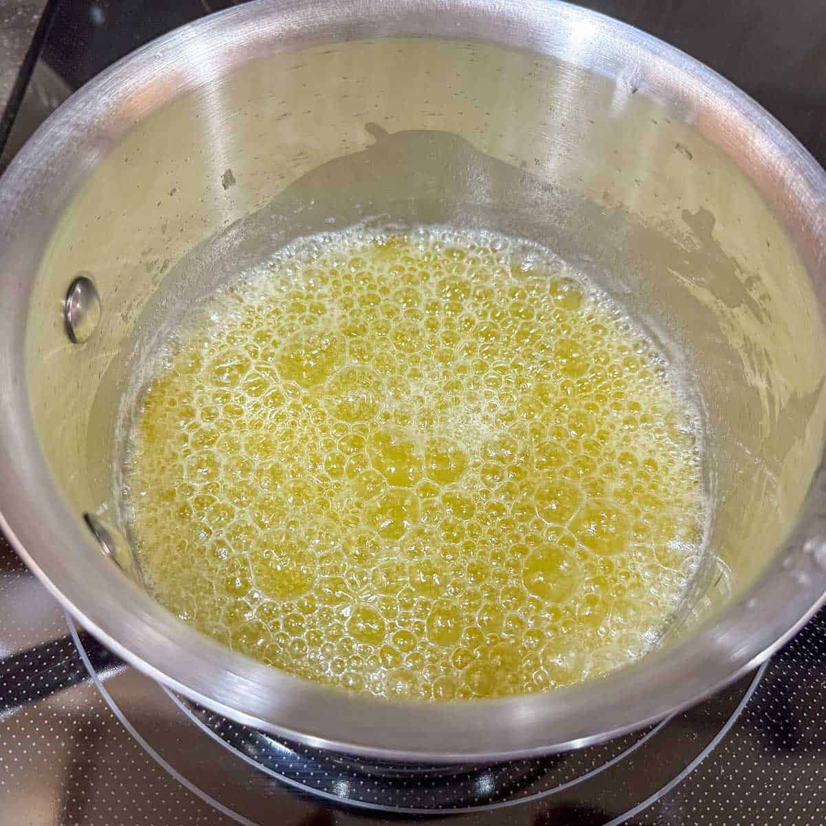 heating butter in a saucepan that is almost at the clear stage.