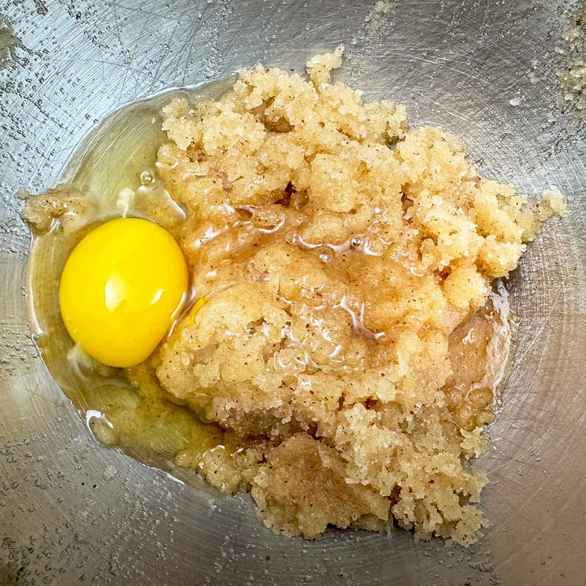 Adding an egg to the brown butter and sugar.