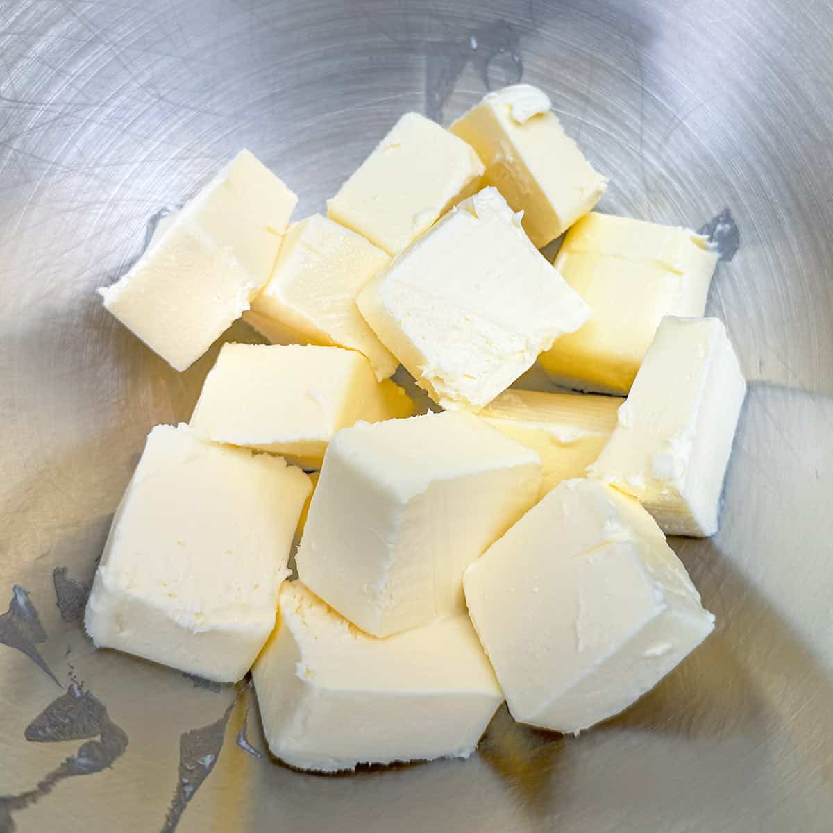 Cubed butter in a mixer bowl.