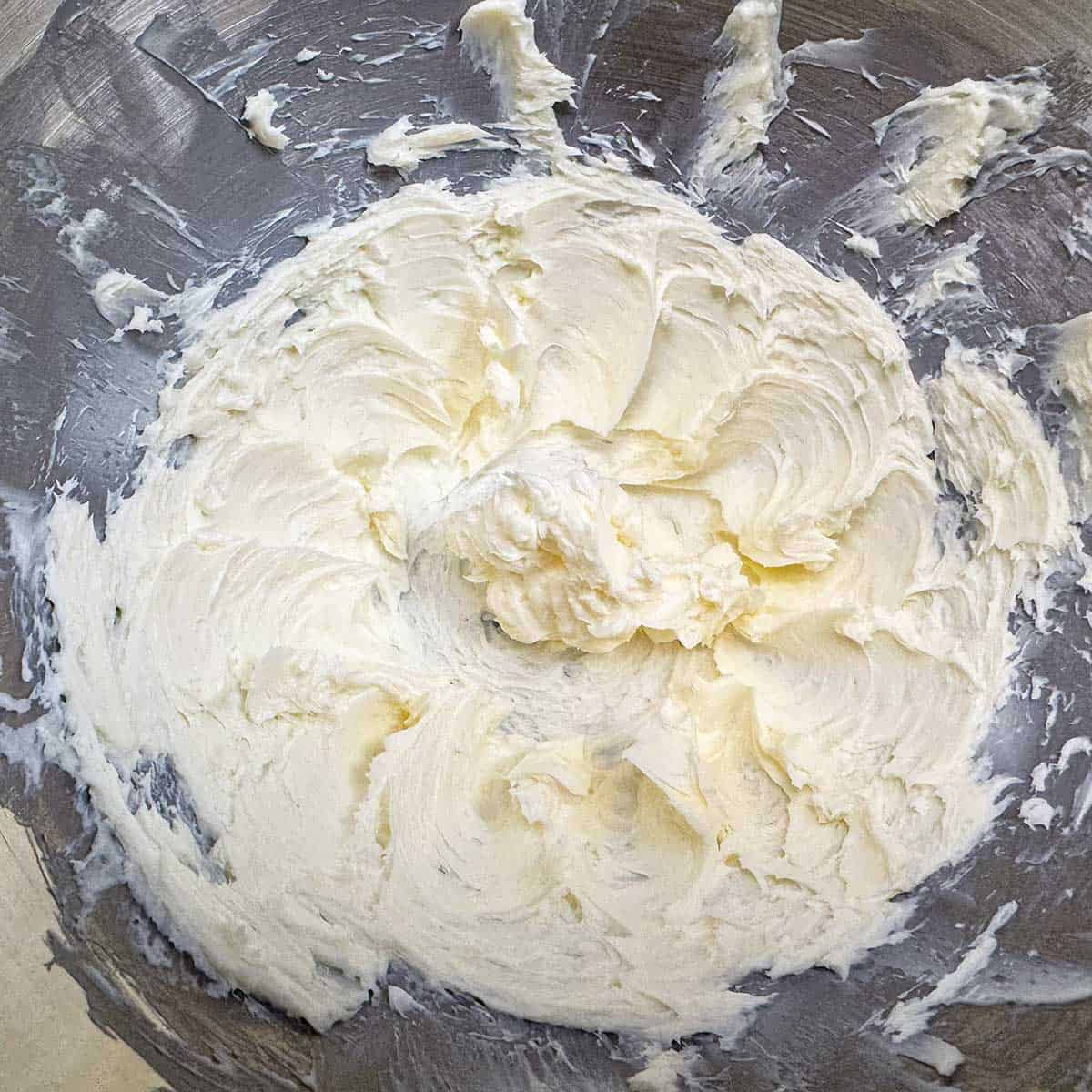 Creamed butter in a mixer bowl.