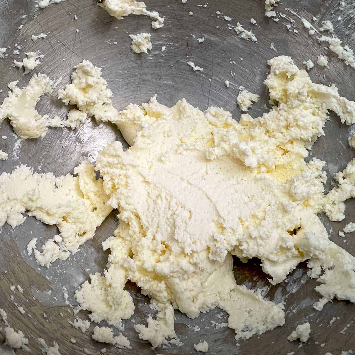 Butter and cream cheese mixed in a mixer bowl.