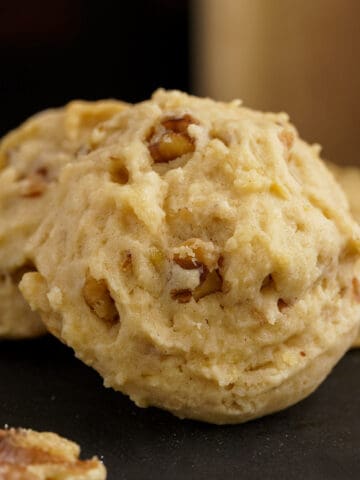 A front view of a glazed maple walnut cookie.