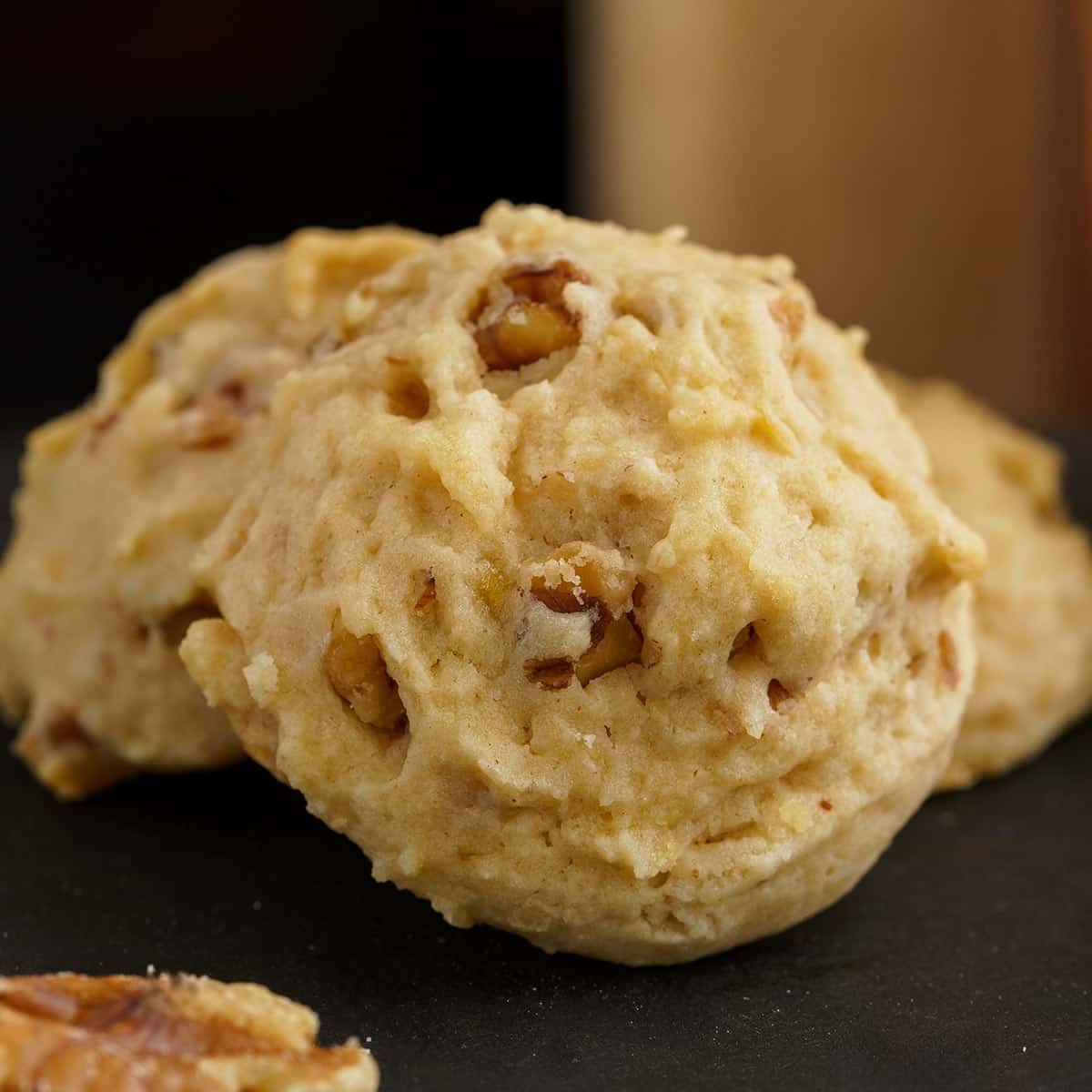 A front view of a glazed maple walnut cookie.