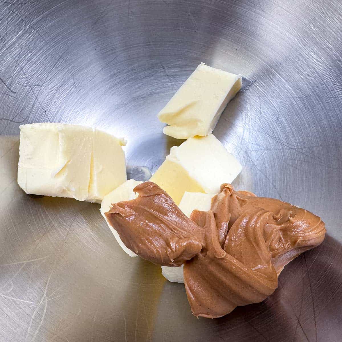Peanut butter and butter in a mixing bowl.