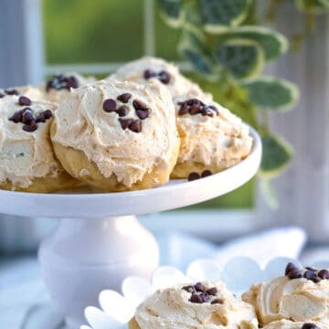 Banana Cookies with Peanut Butter Icing sitting on a round pedestal.