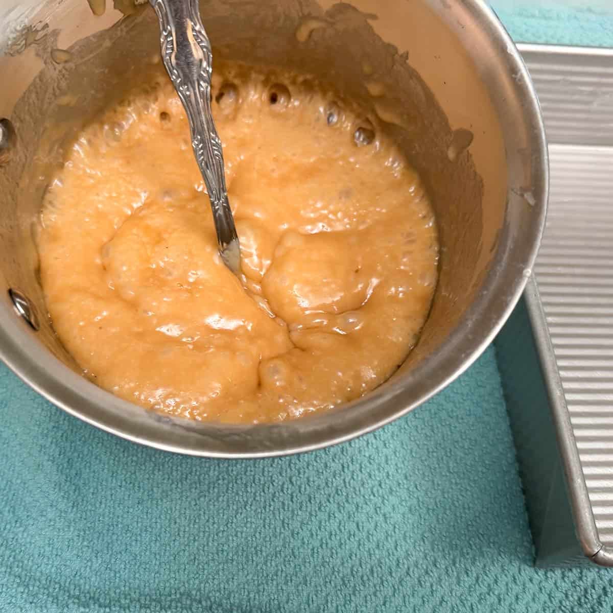 Toffee finished cooking and just before toasted almonds are added.