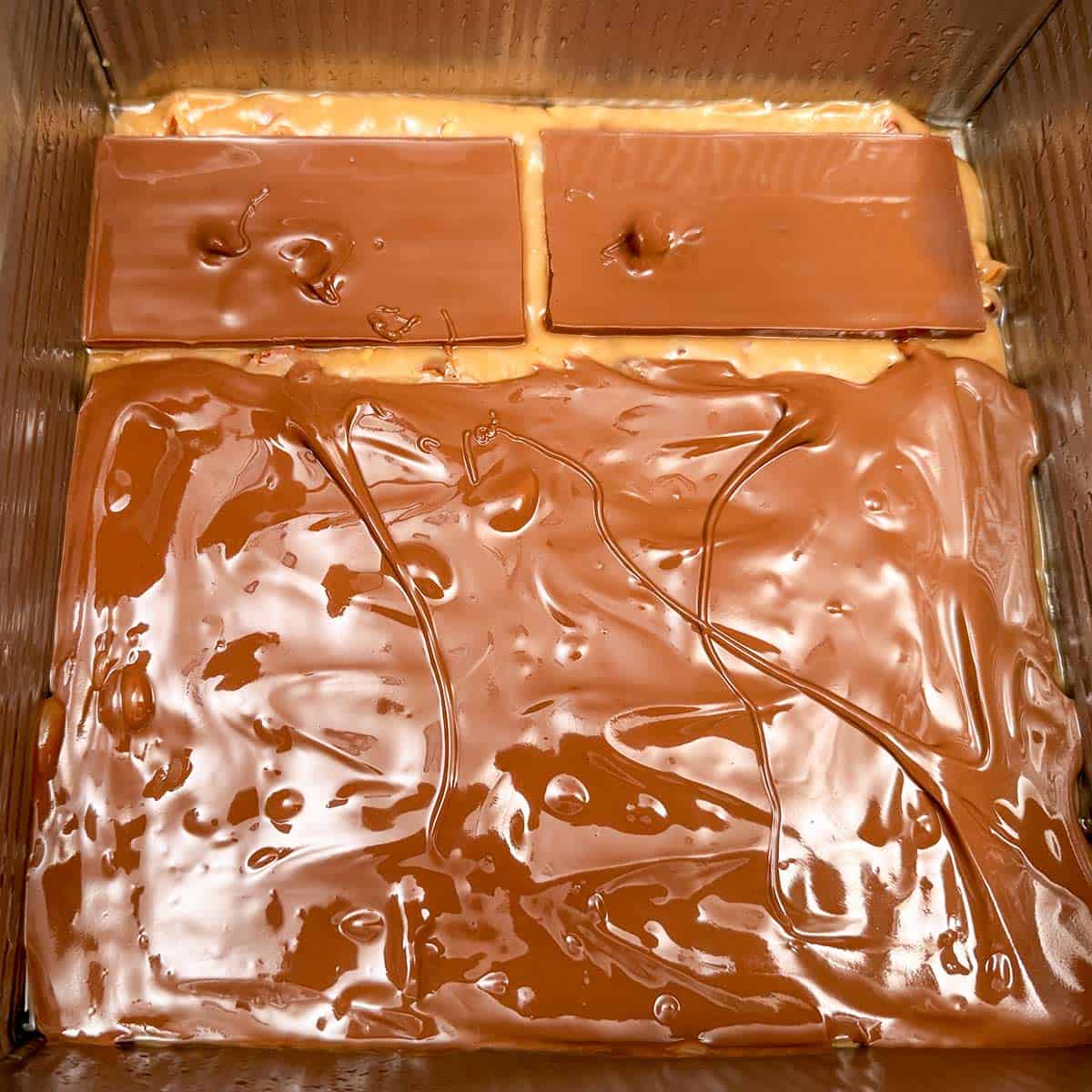 Spreading the melted chocolate around on top of the toffee.