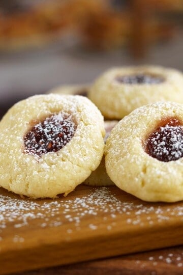 A group of Raspberry Cream Cheese Cookies on a wooden board.