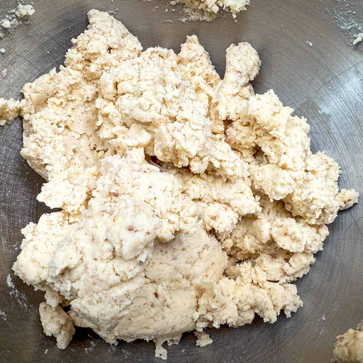 Cookie dough mixed after flour has been added into a mixer bowl.