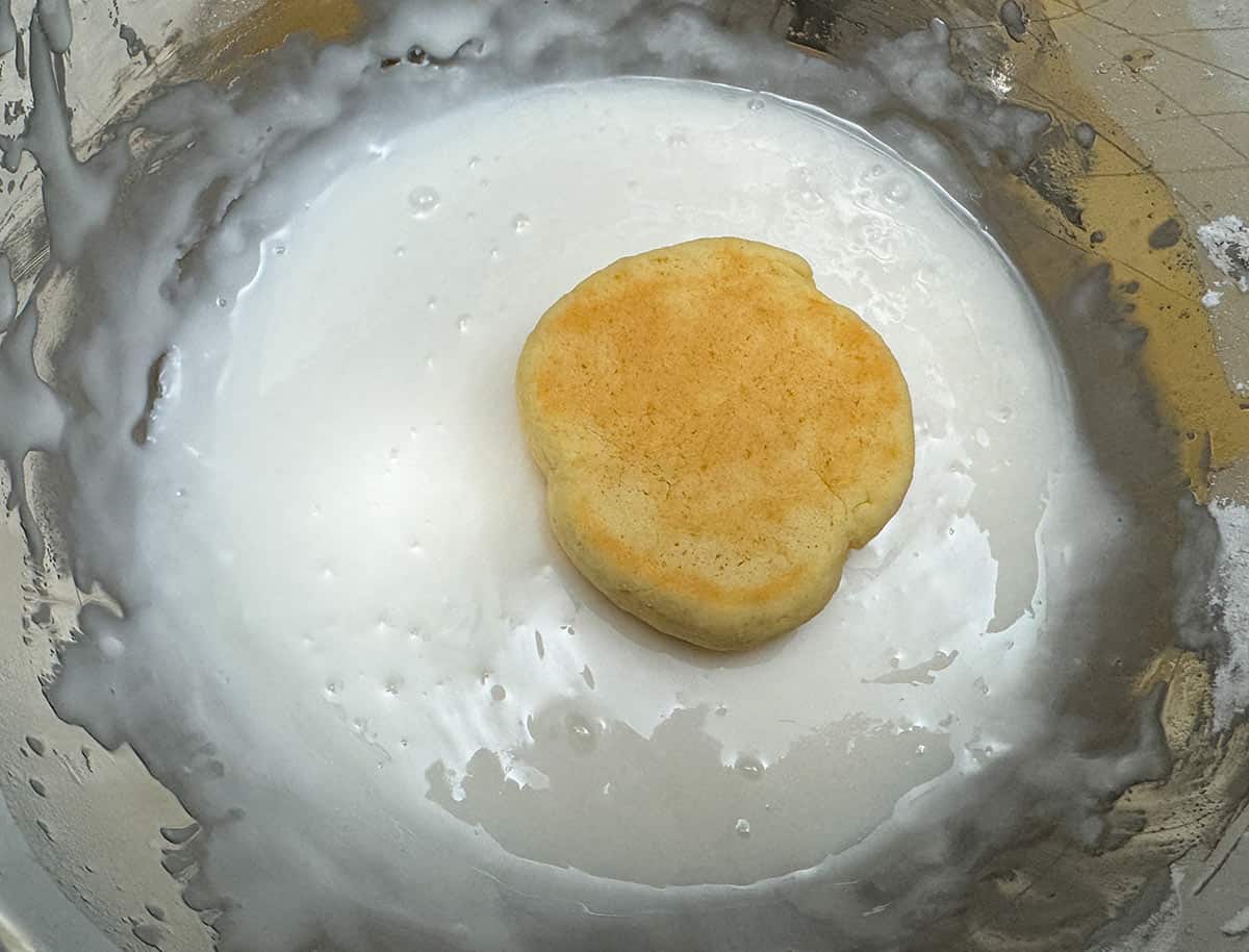 Dipping the top of the cookie into the bowl with the icing.