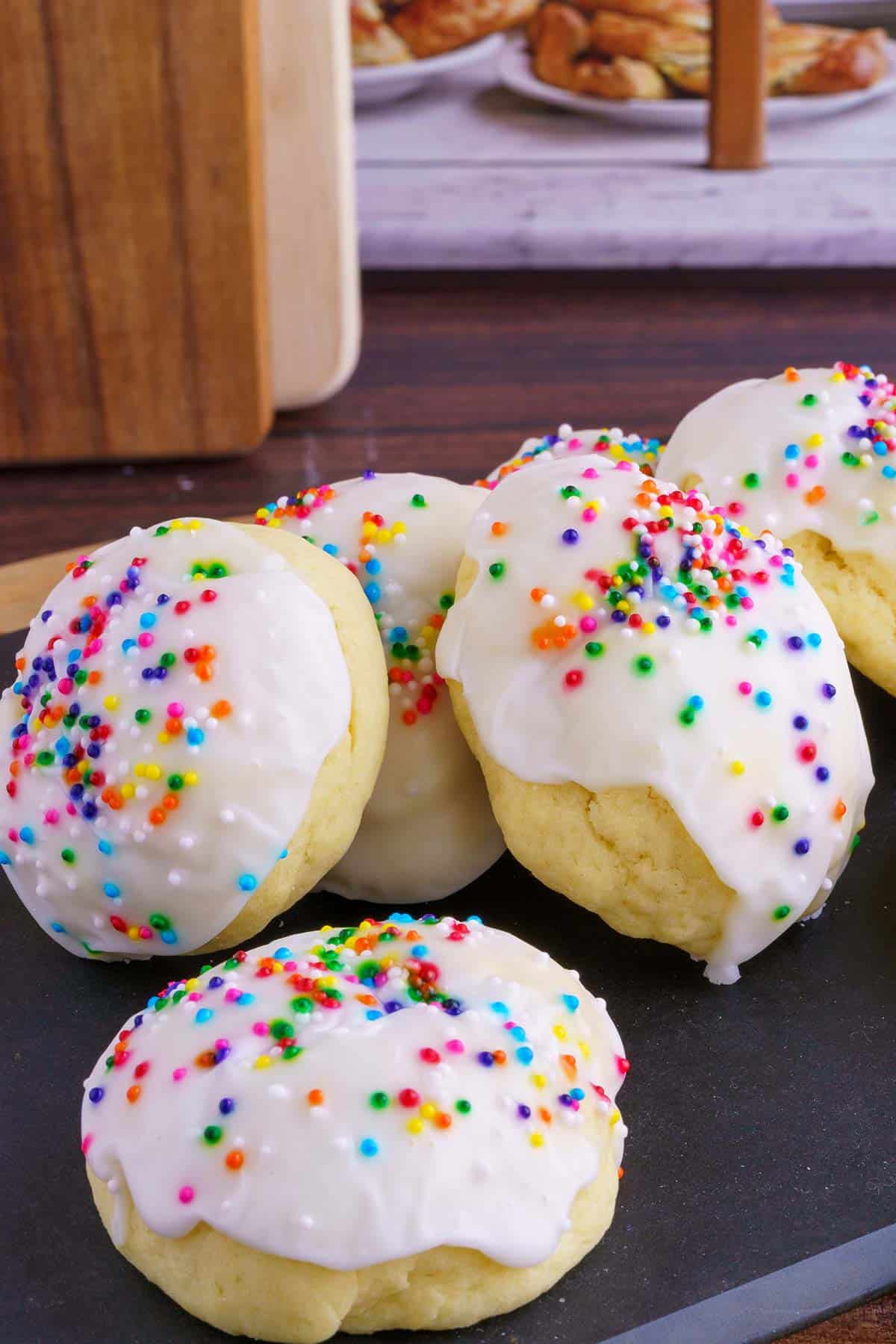 Italian Anise Cookies - Soft, Glazed and Perfect for the Holidays sitting on a board in front of a window.