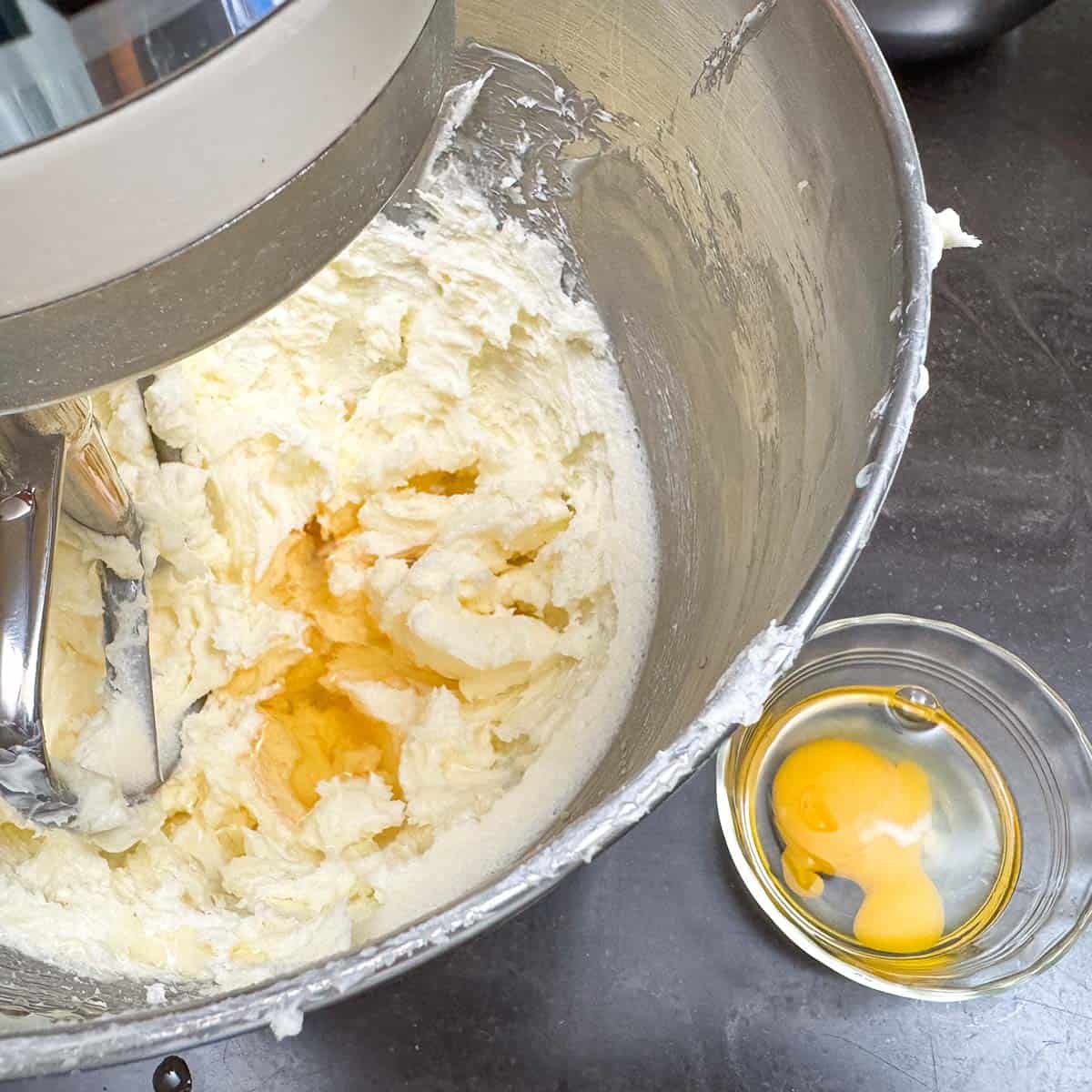 Adding the apple juice and egg into a mixer bowl.