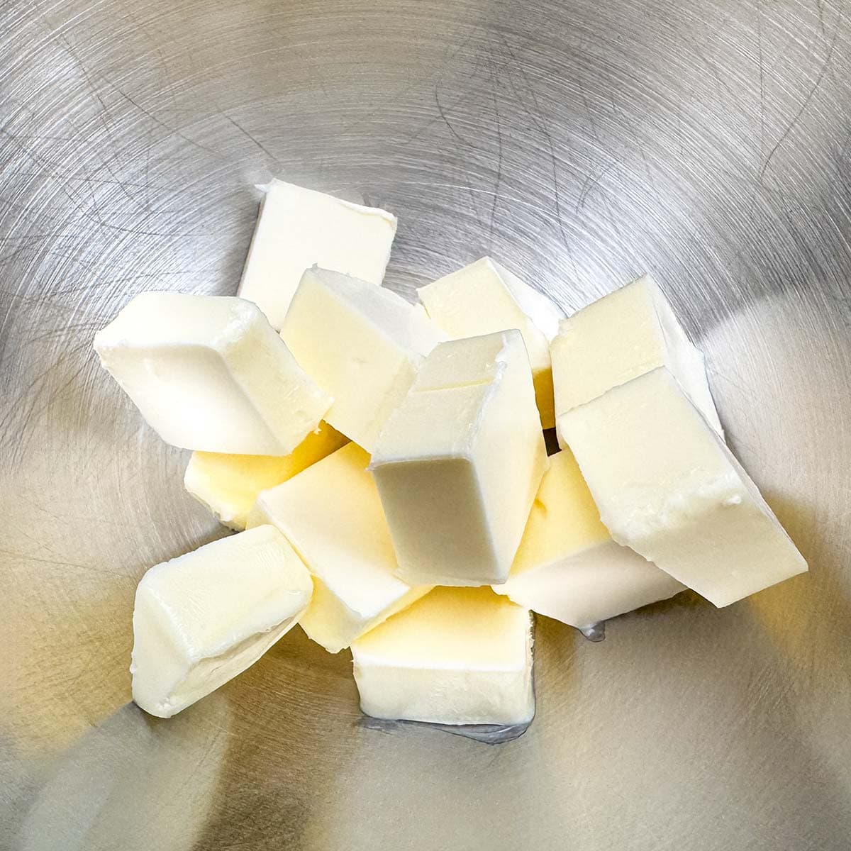 Butter in a mixer bowl that is cubed.