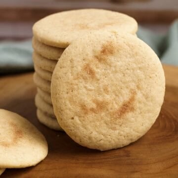 Apple cinnamon sugar cookies on a wooden board for feature photo.
