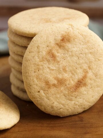 Apple cinnamon sugar cookies on a wooden board for feature photo.