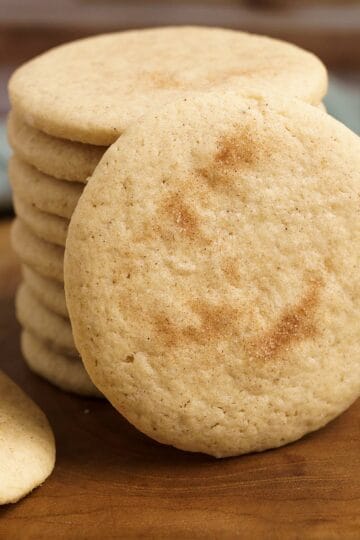 Apple cinnamon sugar cookies on a wooden board for feature photo.