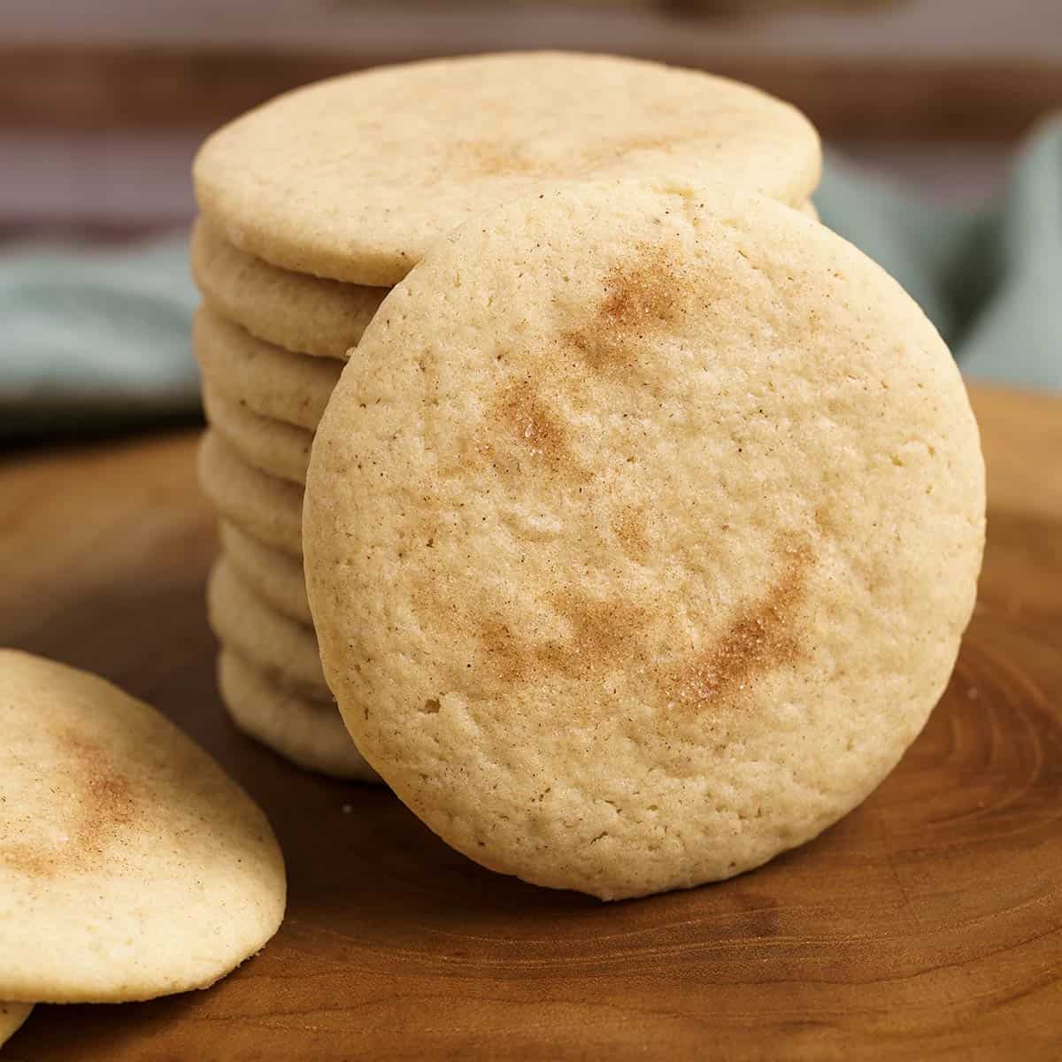 Apple cinnamon sugar cookies on a wooden board for feature photo.