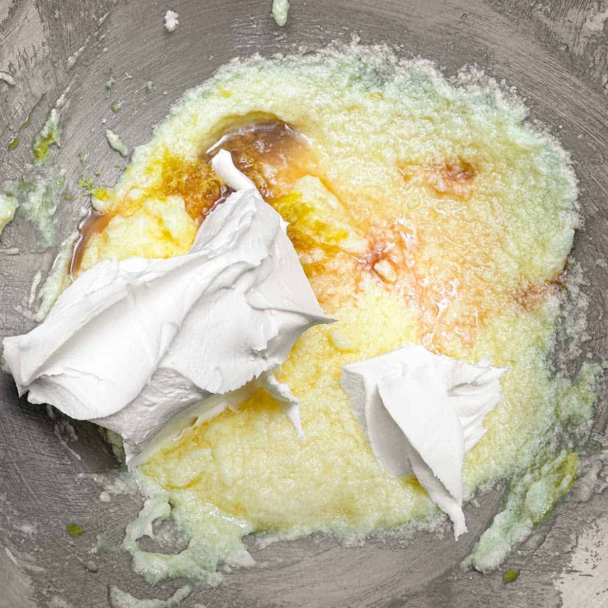 Adding mascarpone cheese, vanilla extract and lemon to the egg sugar-butter mixture.