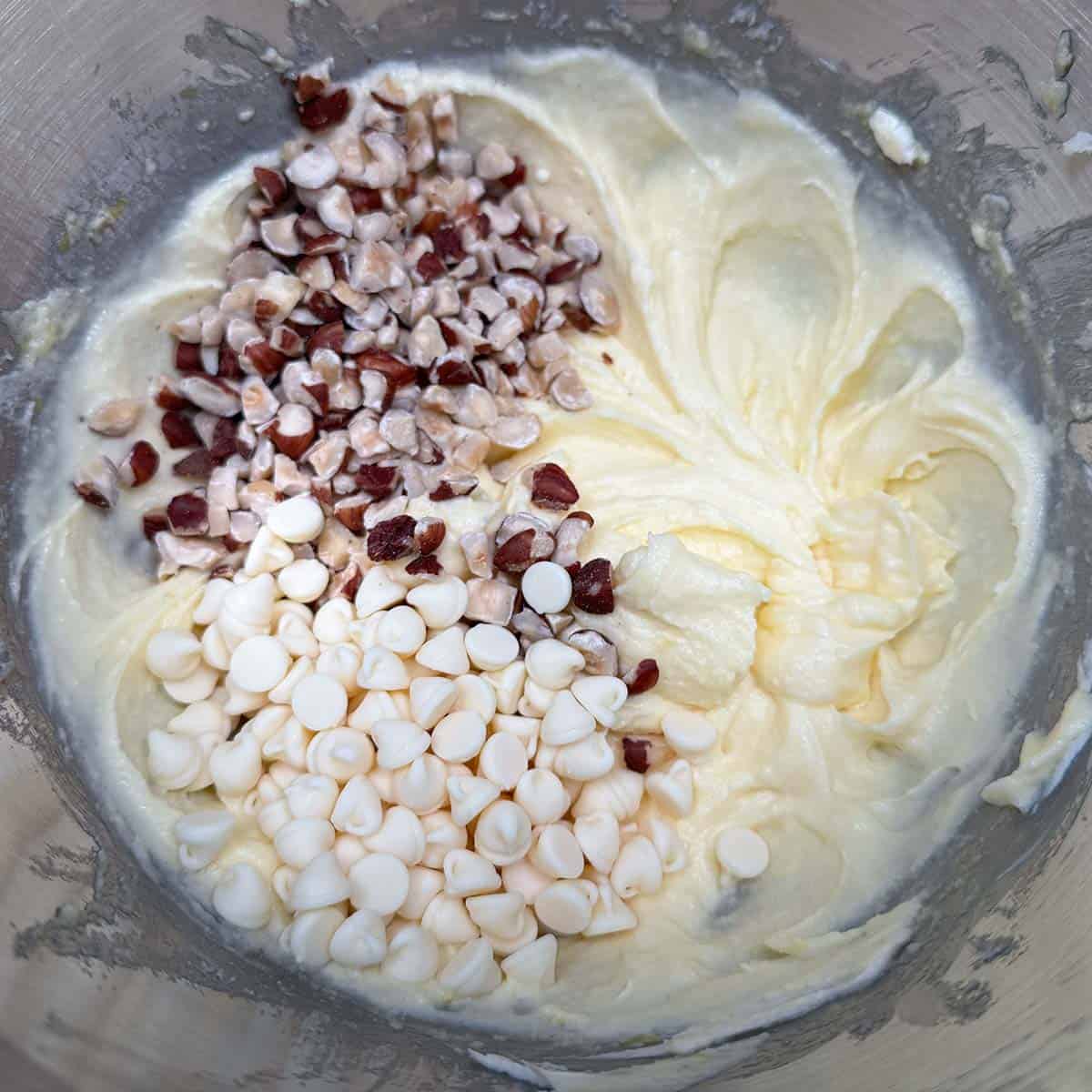 Adding the chopped hazelnuts and white chocolate chip to the cookie dough.