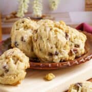Apple cider cookies sitting on a flat plat on top of a wooden board.