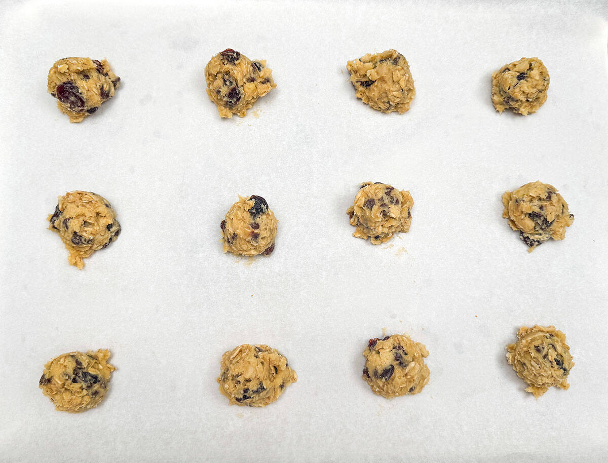 Twelve scoops of cookie dough using a small scooper.