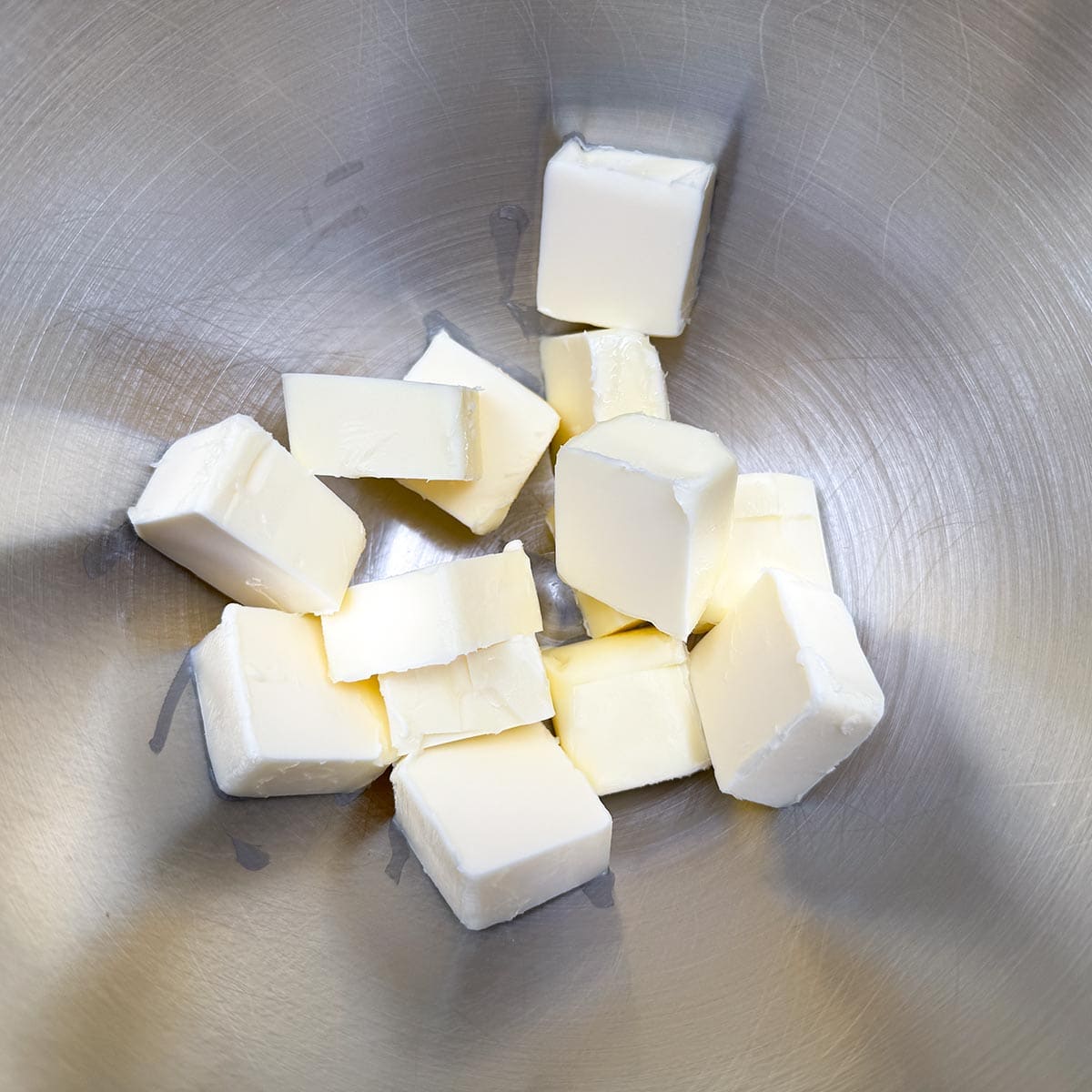 Cubed butter in a mixer bowl.