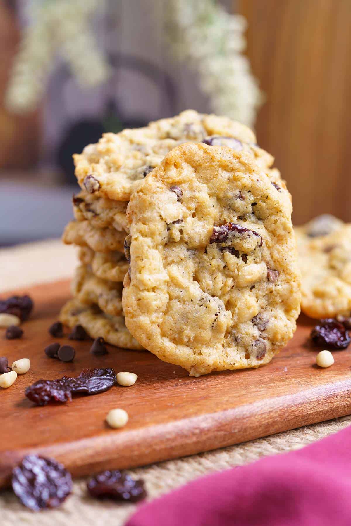 Stack of everything in the bowl oatmeal cookies on a wooden plank.