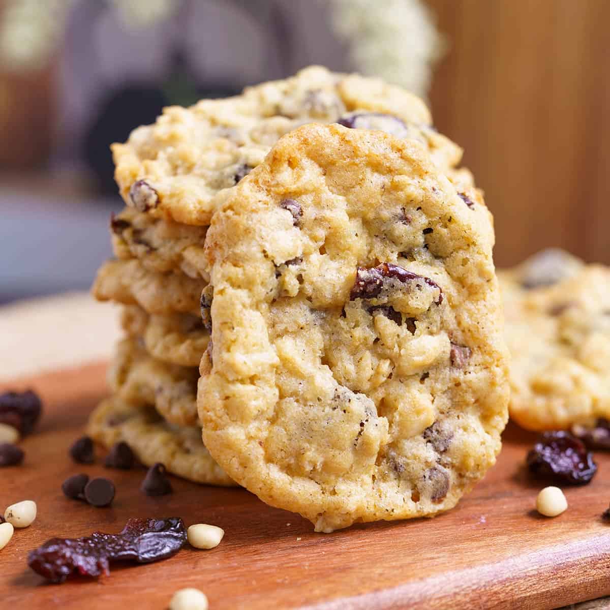 Everything in the bowl oatmeal cookies stacked on a wooden board.