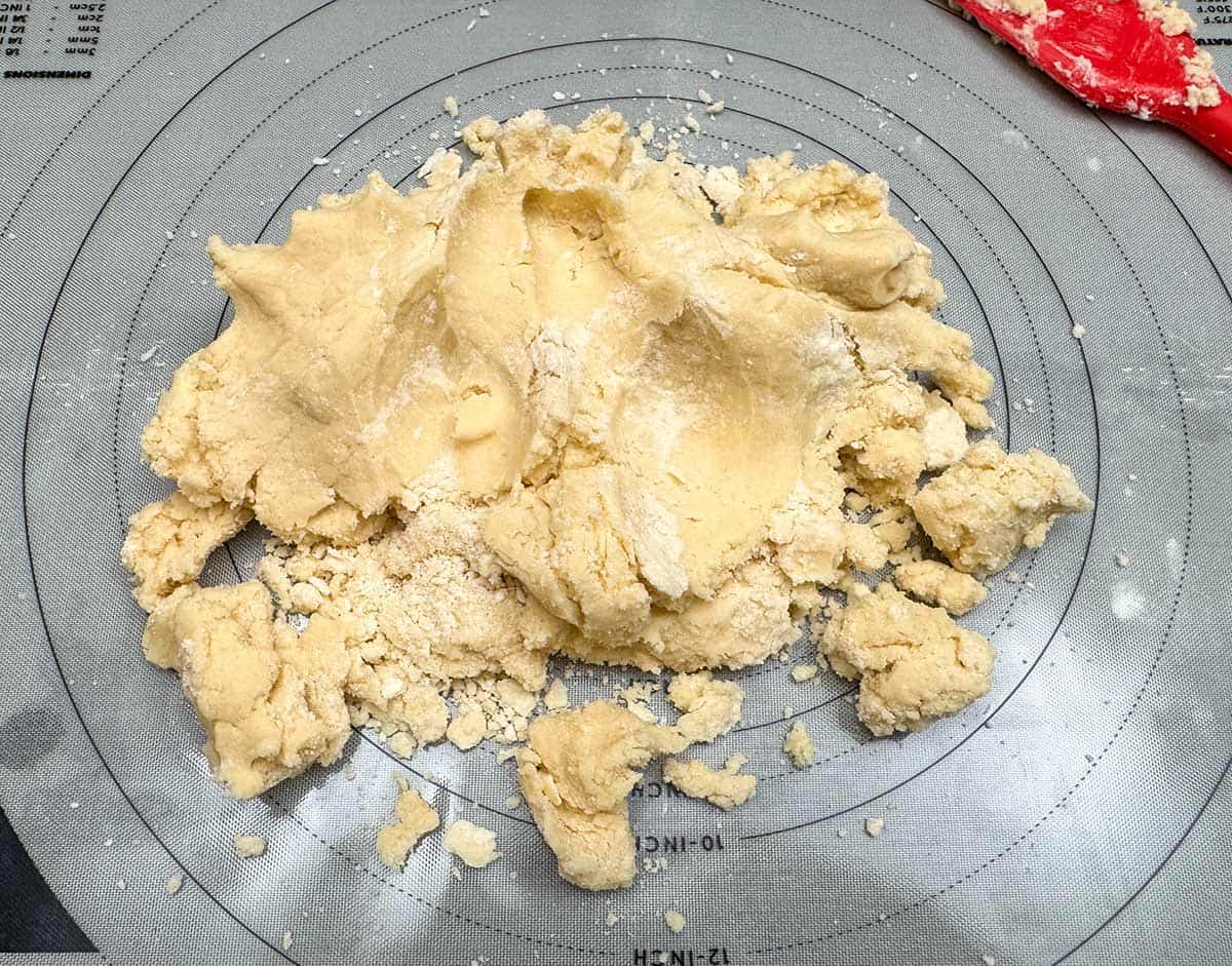 Adding all the cookie dough onto a pastry sheet. Including all the dry flour bits.