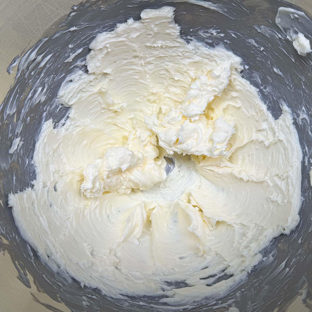 Cubed butter that has been creamed into soft peaks and creamy looking.